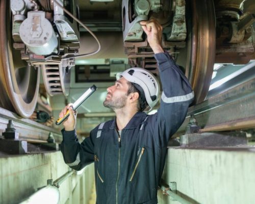 Railway technicians inspect the suspension brakes and axle stability control systems of electric Railway technicians inspect the suspension brakes and axle stability control systems of electric