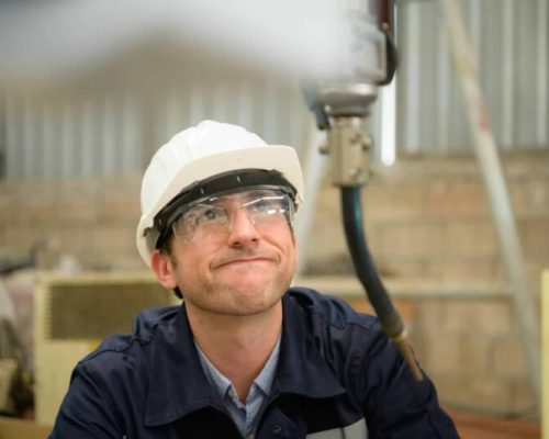 Young male engineers with experience are maintaining and testing the functionality of welding robots Young male engineers with experience are maintaining and testing the functionality of welding robots
